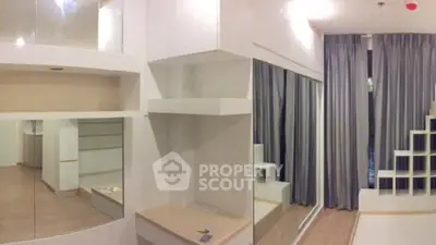 Modern minimalist living room with large mirrors and sleek shelving units.