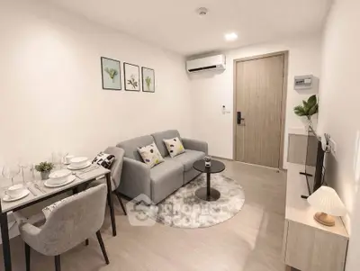 Modern living room with cozy sofa, dining area, and stylish decor in a compact apartment.