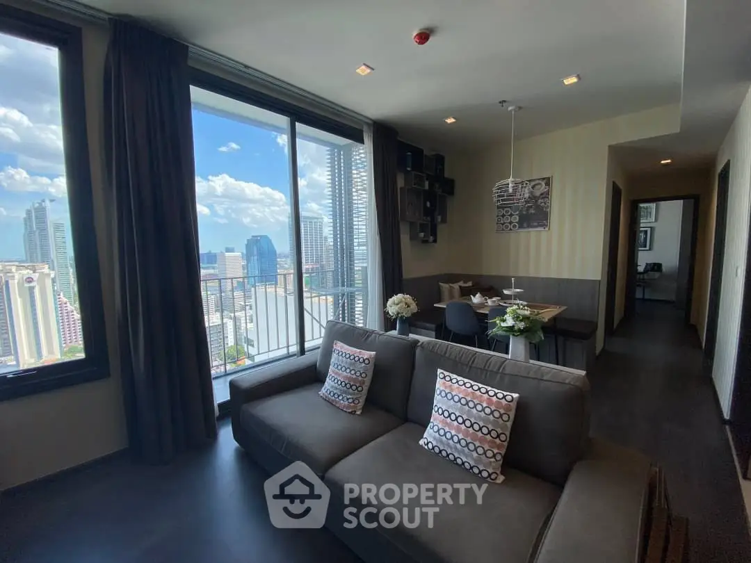 Modern living room with city view and stylish decor in high-rise apartment