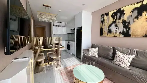 Luxurious modern living room with chic decor and open kitchen layout.