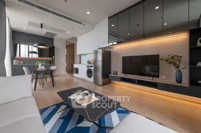 Modern open-plan living room with sleek kitchen and stylish decor