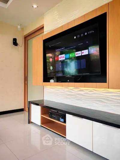 Modern living room with wall-mounted TV and sleek entertainment unit