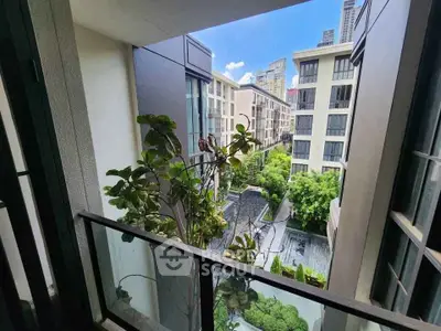 Modern urban balcony with lush greenery and city view