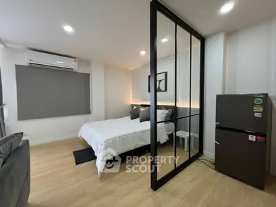 Modern bedroom with glass partition and sleek decor