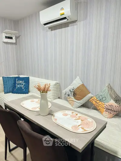 Cozy dining area with stylish decor and air conditioning, perfect for intimate gatherings.