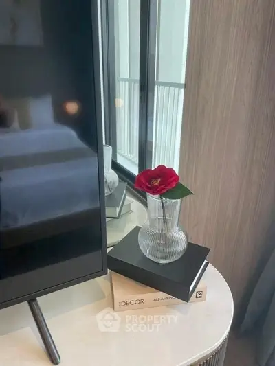 Stylish bedroom corner with modern decor and elegant vase near window.
