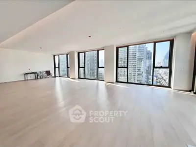 Spacious modern living room with large windows and city view in luxury apartment
