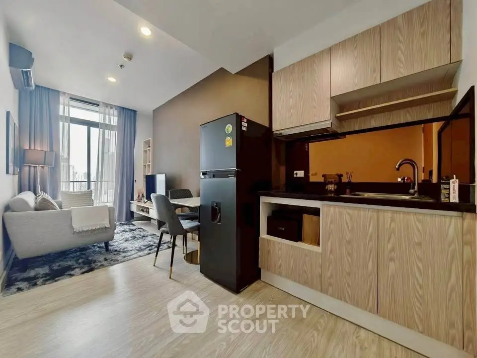 Modern open-plan living room and kitchen with stylish decor and natural light.