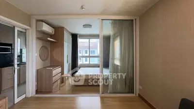 Modern studio apartment with sliding glass partition and natural light