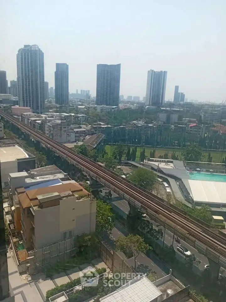 Stunning cityscape view with modern high-rise buildings and railway, perfect for urban living enthusiasts.