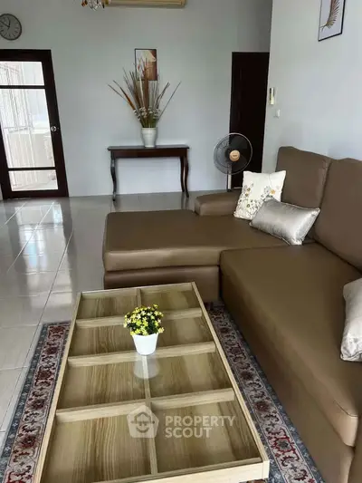 Spacious living room with modern brown sofa and elegant decor