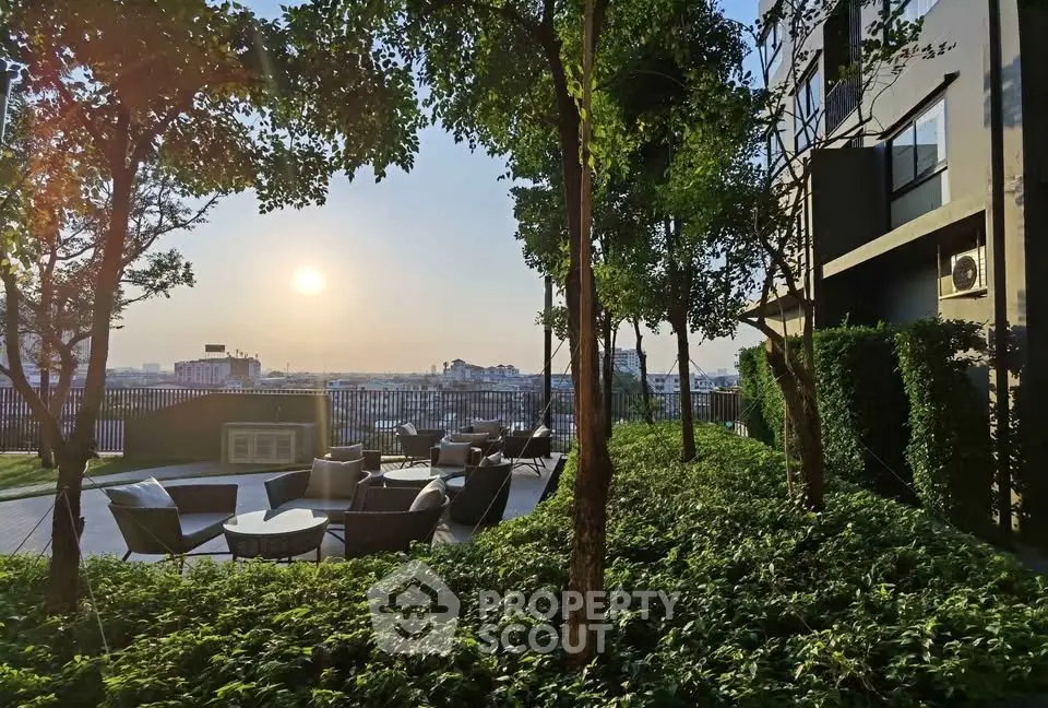 Stunning garden view with outdoor seating and sunset at modern residential building.