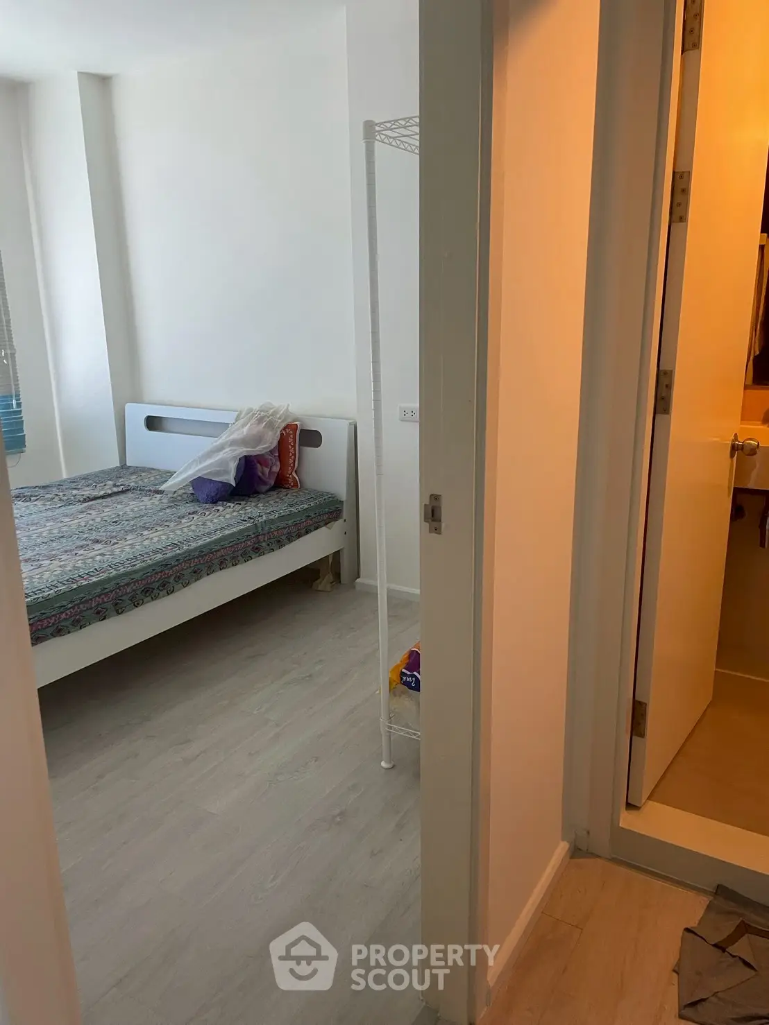 Cozy bedroom with adjacent bathroom in modern apartment