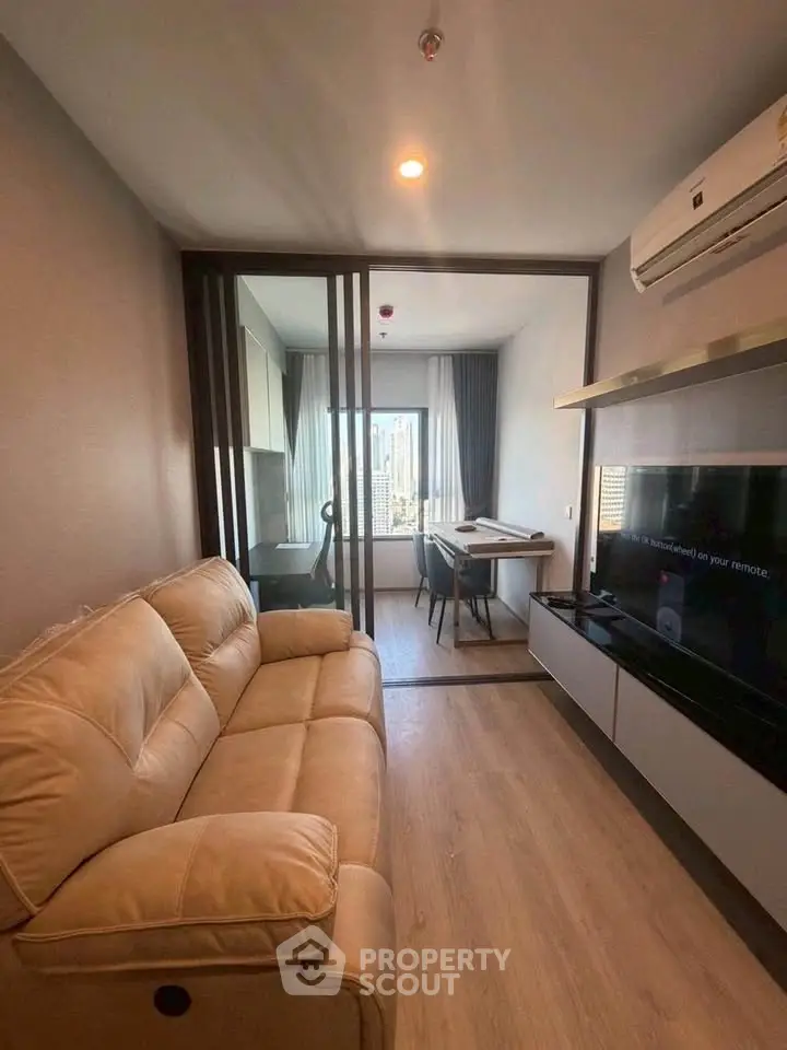 Modern living room with cozy sofa and city view, perfect for urban living.