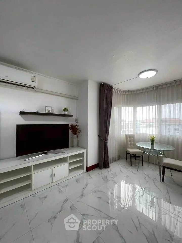 Modern living room with marble flooring and natural light