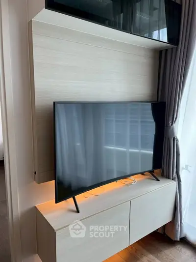 Modern living room with sleek TV and stylish cabinetry, perfect for contemporary urban living.