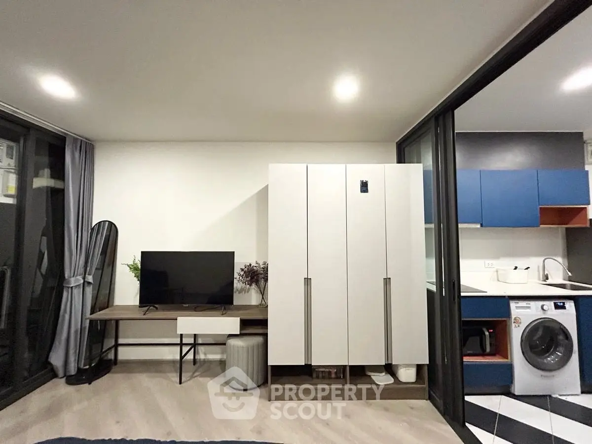 Modern apartment interior with sleek furniture and in-unit washing machine