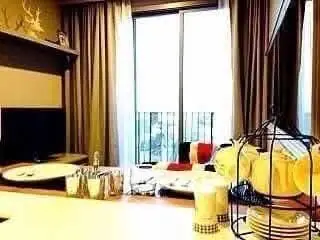 Cozy living room with modern decor and balcony view, perfect for relaxation.