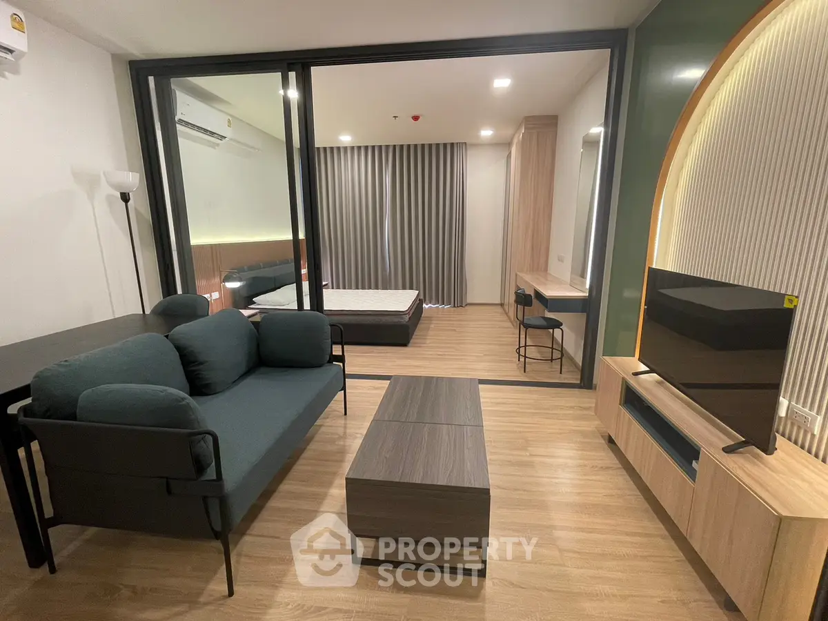 Modern studio apartment with stylish living area and bedroom separation
