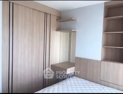 Modern bedroom with built-in wooden wardrobe and shelves