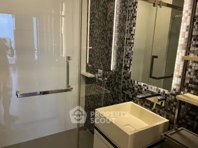 Modern bathroom with sleek design and stylish mosaic tiles.