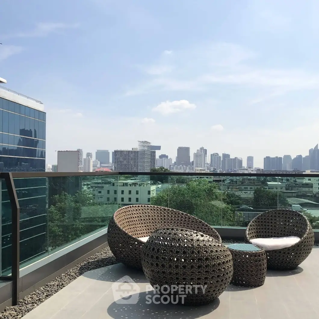 Stunning rooftop terrace with modern furniture and city skyline view