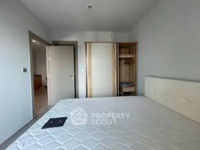 Spacious bedroom with modern wardrobe and comfortable bed