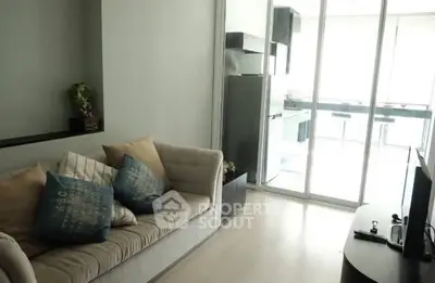 Modern living room with cozy sofa and open kitchen layout