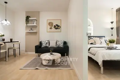 Modern open-plan living room and bedroom with stylish decor and cozy ambiance.
