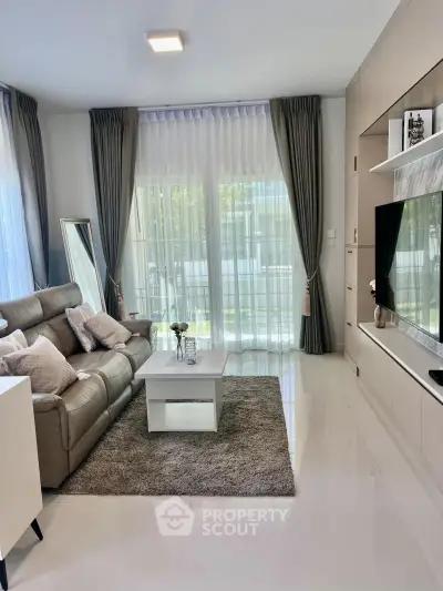 Modern living room with sleek furniture and large windows for natural light