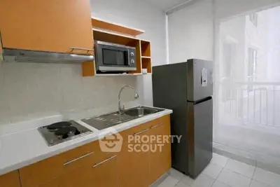 Modern kitchen with sleek cabinets, stainless steel appliances, and ample natural light.