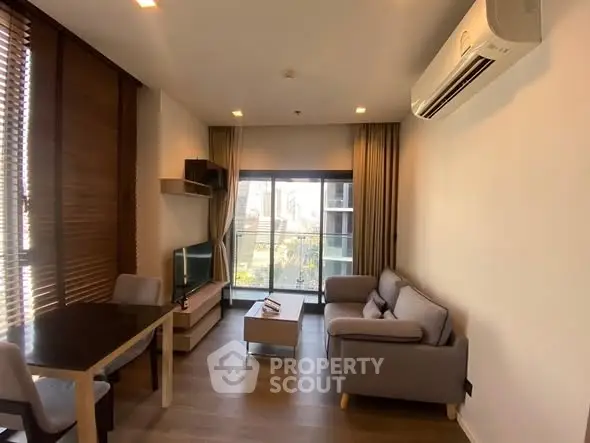 Modern living room with cozy seating and large window view