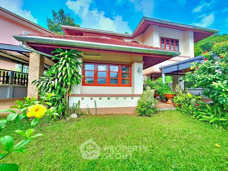 Charming two-story house with lush garden and vibrant exterior, perfect for family living.