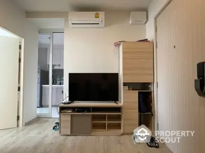 Modern living room with TV and air conditioning in cozy apartment