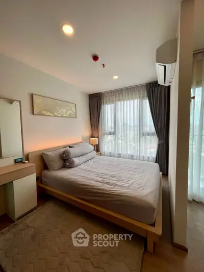 Modern bedroom with large windows and stylish decor in a high-rise apartment.