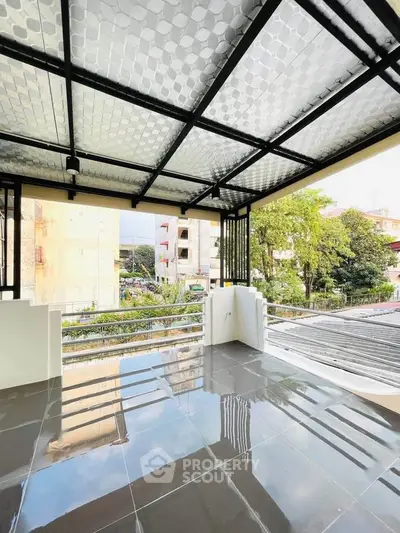 Spacious balcony with modern design and city view, perfect for relaxation and entertainment.