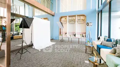 Spacious modern living area with high ceilings and stylish decor, perfect for photography or events.