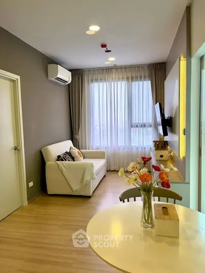 Modern living room with cozy sofa and stylish decor in a bright apartment.