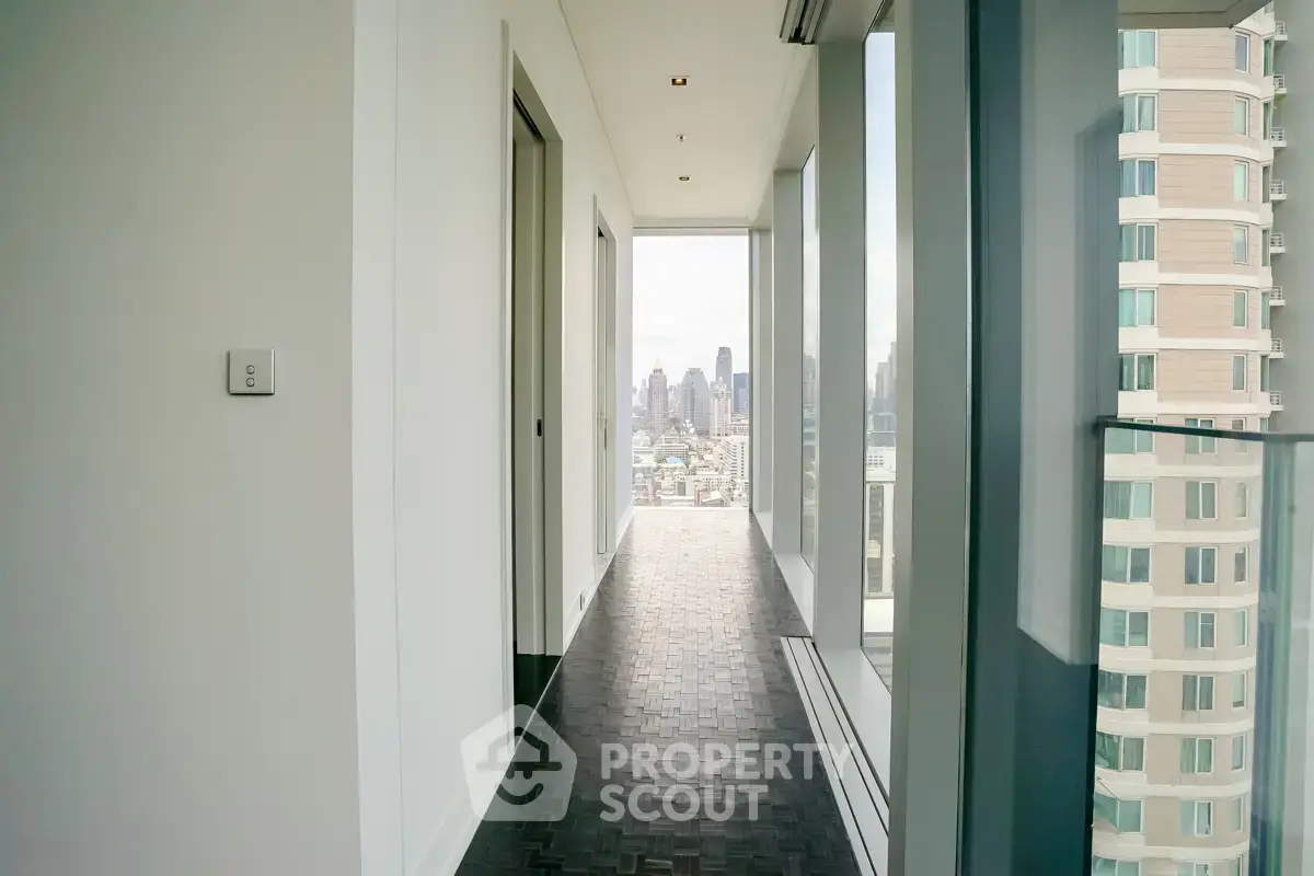 Sleek modern corridor with city skyline view in luxury high-rise apartment.