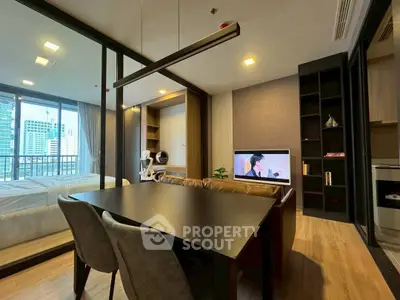 Modern studio apartment with open layout, featuring a cozy living area and city view.