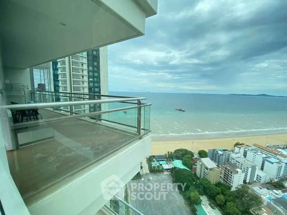 Stunning ocean view from a high-rise balcony overlooking the beach and cityscape.