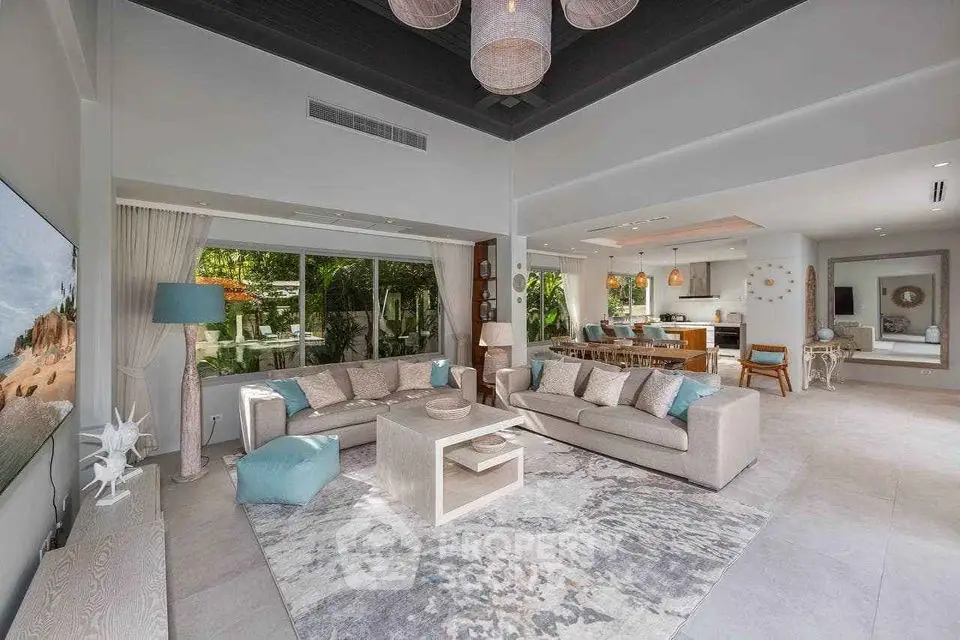 Luxurious open-plan living room with modern decor and garden view