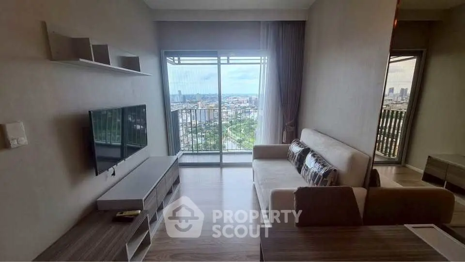 Modern living room with balcony and stunning city view, featuring sleek furniture and natural light.