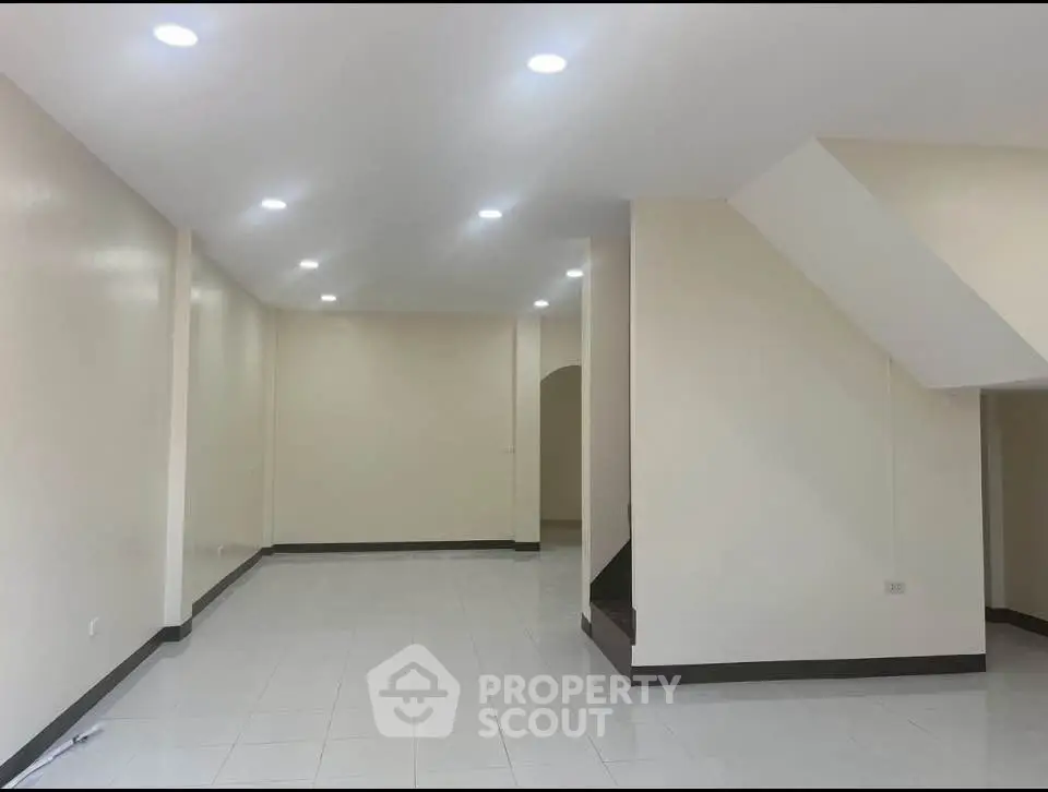 Spacious open-plan interior with modern lighting and neutral tones, ideal for versatile living arrangements.