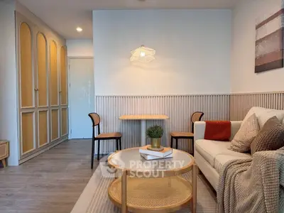 Chic modern living room with cozy sofa, stylish lighting, and elegant decor.