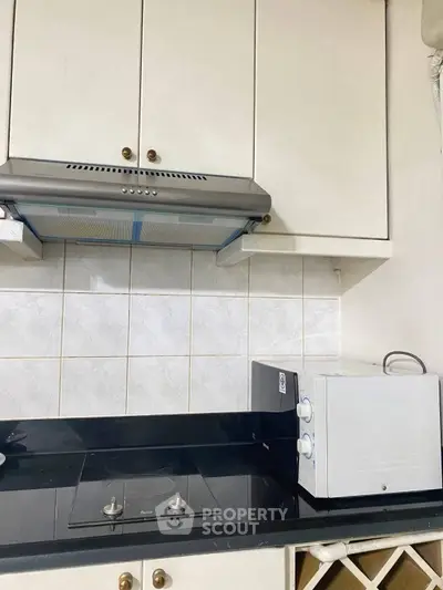 Modern kitchen with sleek black countertop and built-in electric stove