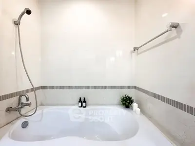 Modern bathroom with elegant bathtub and stylish fixtures, perfect for relaxation.