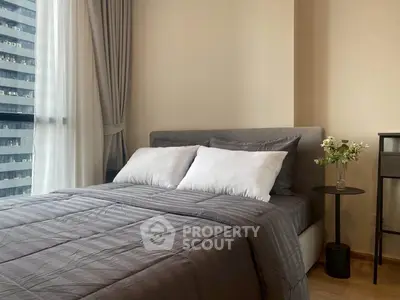 Modern bedroom with stylish decor and large window in urban apartment