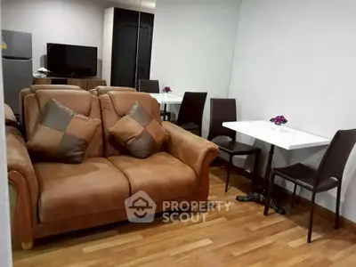 Cozy living room with brown leather sofa and dining area, perfect for modern living.