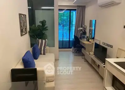 Modern living room with stylish decor and balcony view in a cozy apartment.